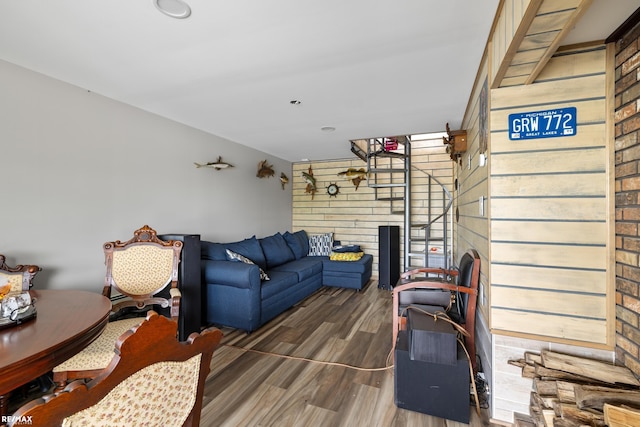 living area with wooden walls and wood finished floors
