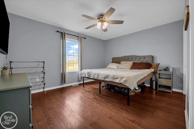 bedroom with baseboards, a ceiling fan, and wood finished floors
