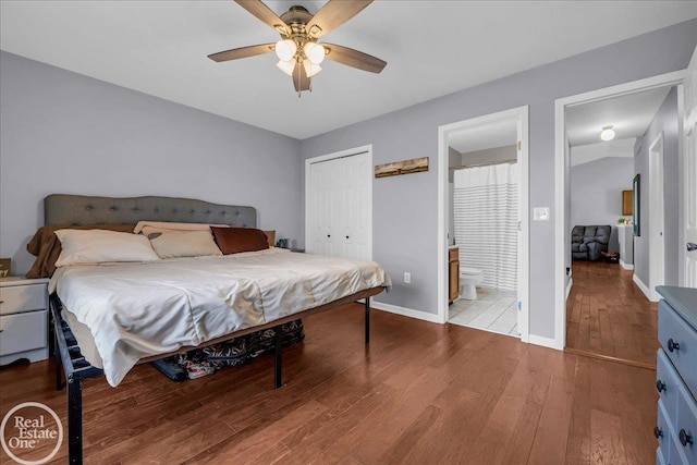 bedroom with ensuite bathroom, a closet, wood finished floors, a ceiling fan, and baseboards