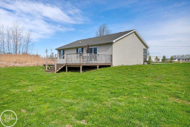 rear view of house with a lawn and a deck