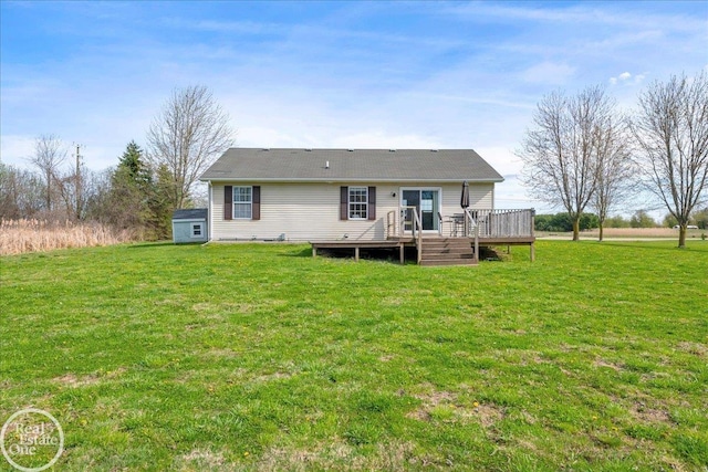 rear view of property featuring a yard and a deck