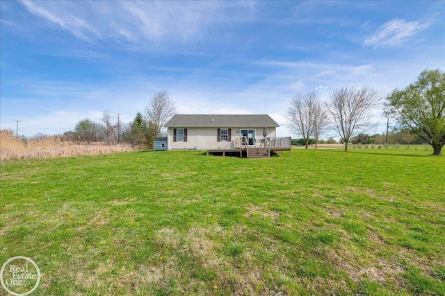 back of property featuring a yard and a wooden deck