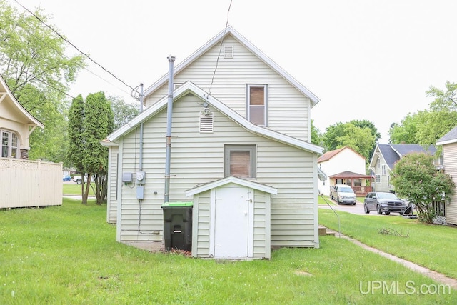 back of house with a lawn