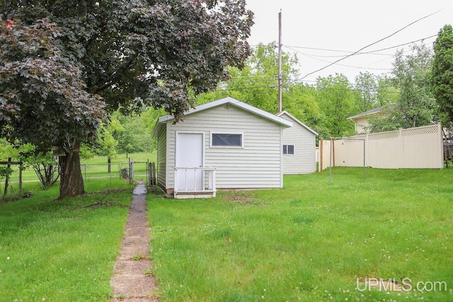 view of yard with an outbuilding and fence