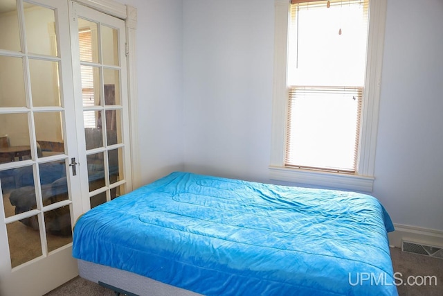 bedroom with carpet, french doors, and visible vents