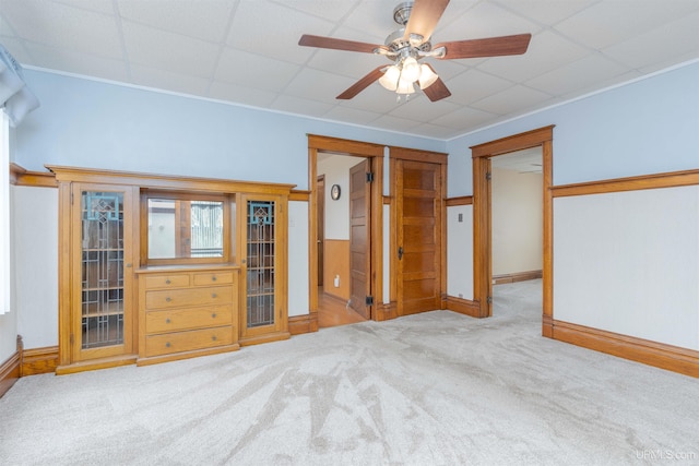bedroom with carpet flooring, ceiling fan, and a paneled ceiling
