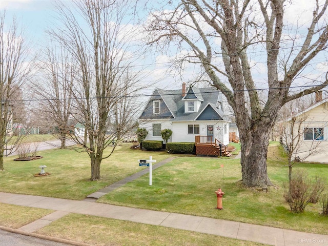 cape cod-style house with a front lawn and a chimney