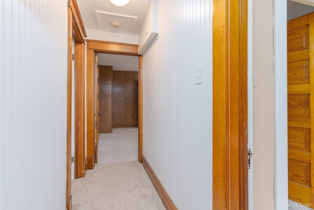 hall featuring light carpet