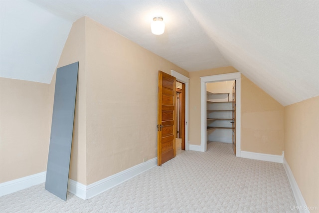 additional living space with lofted ceiling and carpet floors