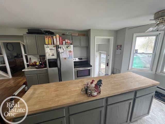 kitchen featuring gray cabinetry, light countertops, a ceiling fan, and appliances with stainless steel finishes