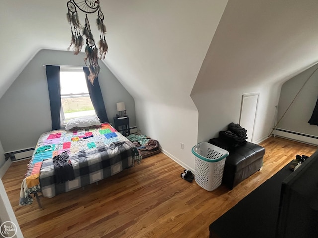 bedroom featuring vaulted ceiling, a baseboard radiator, baseboards, and wood finished floors