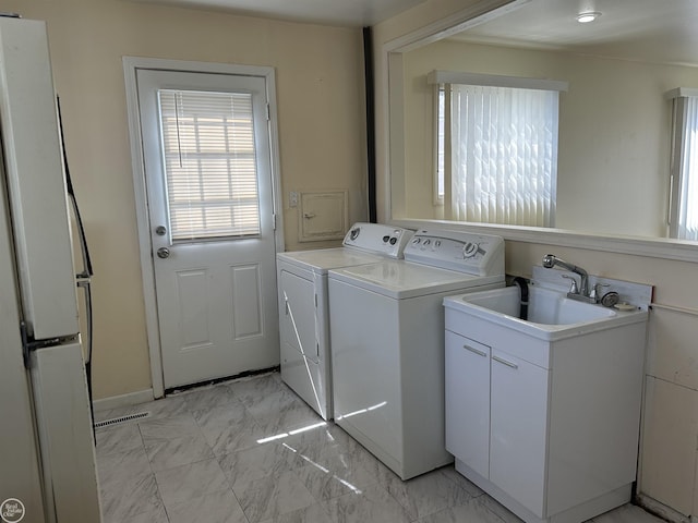 clothes washing area with marble finish floor, separate washer and dryer, laundry area, and visible vents