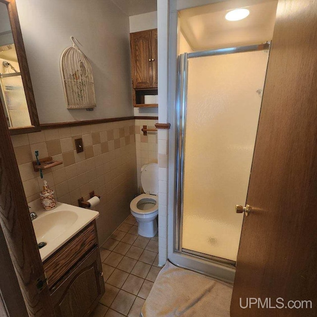 25485 Opal Rd, Watton, MI 49970 - bathroom with a stall shower, tile patterned floors, vanity, tile walls, and a wainscoted wall