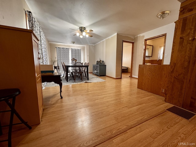 dining space with visible vents, wood finished floors, and ceiling fan