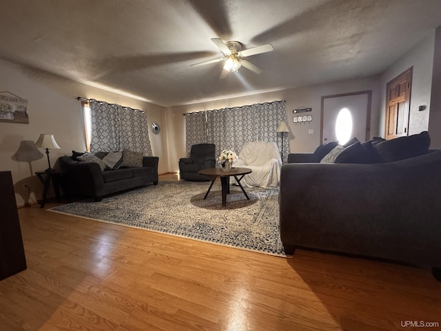 living room with a ceiling fan and wood finished floors