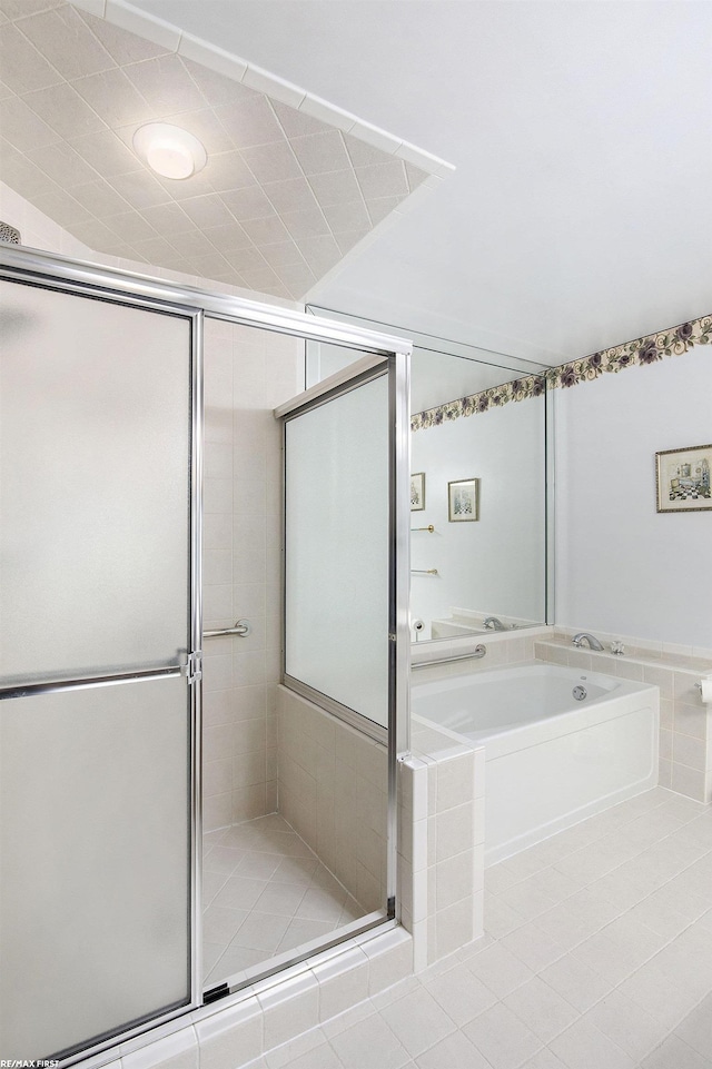 bathroom with a shower stall and a bath