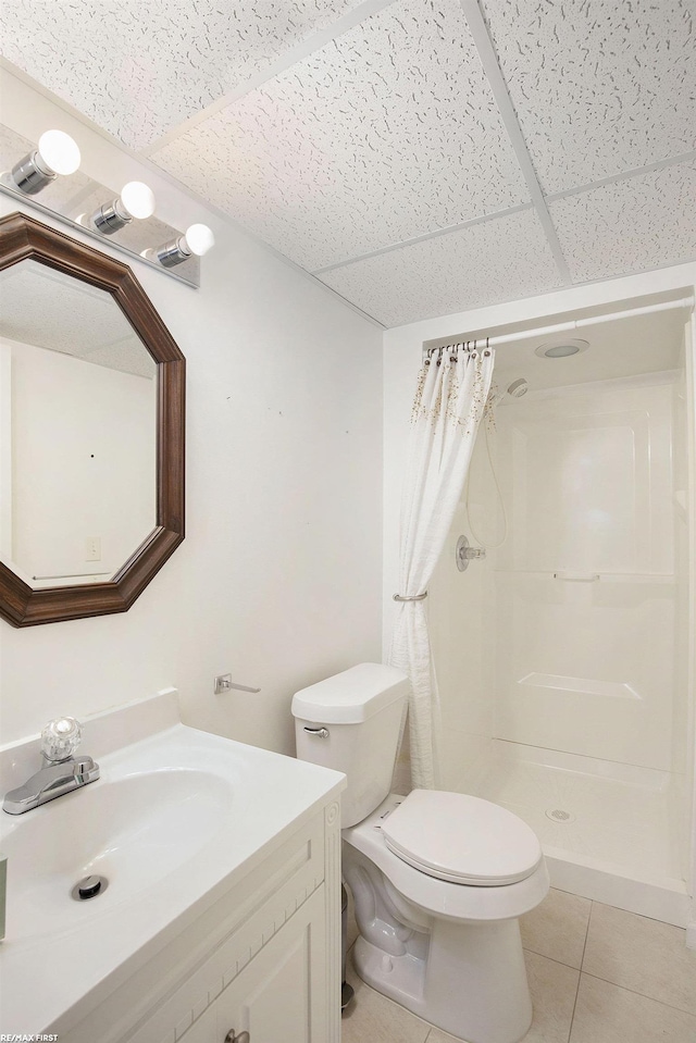 full bathroom with a drop ceiling, toilet, a shower stall, and tile patterned floors