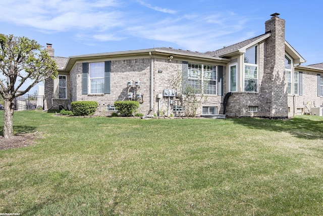 exterior space featuring a front lawn and a chimney