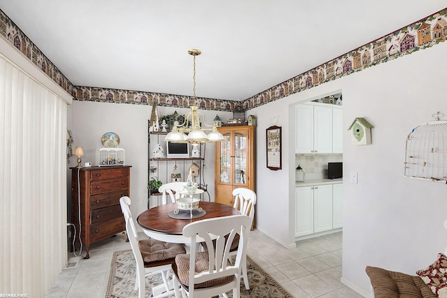 dining area featuring an inviting chandelier and light tile patterned flooring