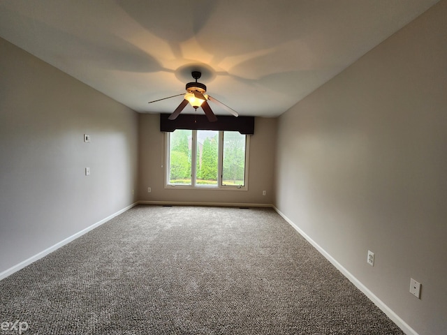 empty room featuring baseboards, a ceiling fan, and carpet floors