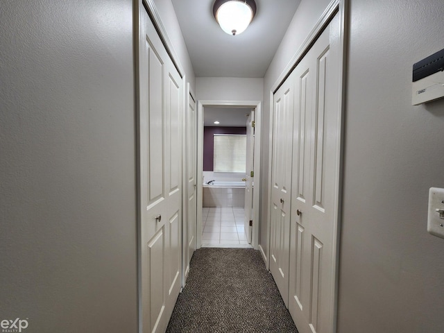 hallway with dark carpet