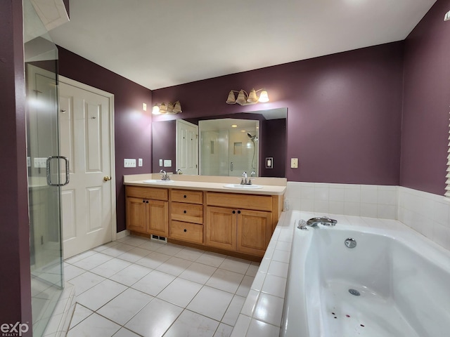bathroom featuring a sink, a shower stall, a bath, and tile patterned floors