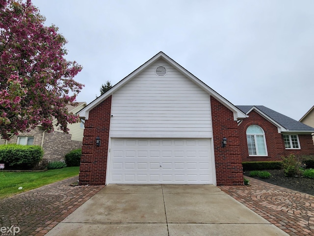 view of front of house featuring brick siding and driveway