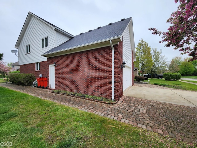 view of home's exterior with a lawn, brick siding, a garage, a shingled roof, and concrete driveway