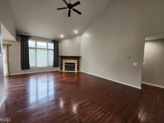 unfurnished living room with a fireplace, ceiling fan, baseboards, and dark wood-type flooring