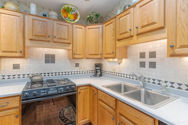 kitchen with a sink, black electric range, decorative backsplash, and light countertops