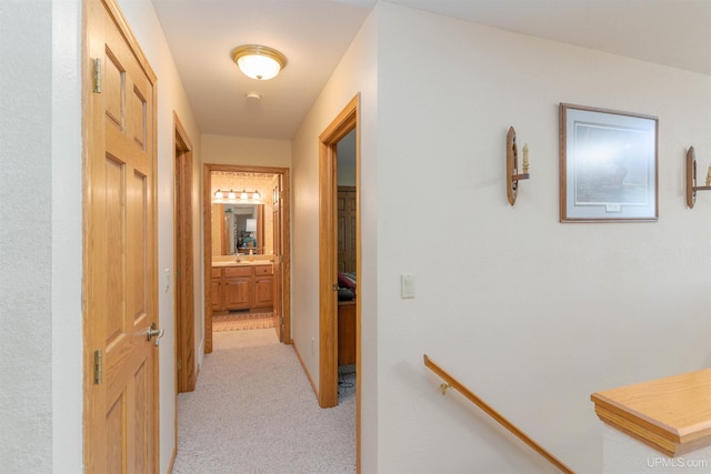 hall featuring light carpet