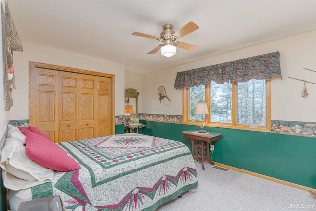 carpeted bedroom featuring ceiling fan, a closet, and visible vents