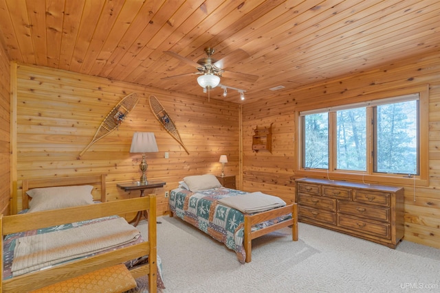 carpeted bedroom featuring wooden walls and wood ceiling