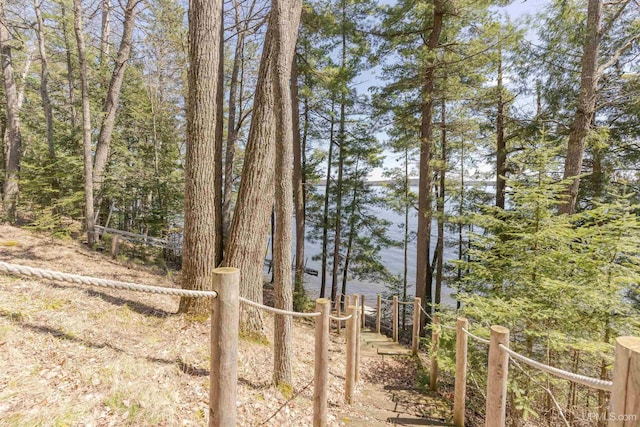 view of yard with a water view and fence