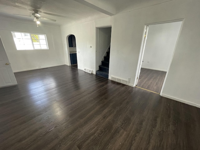 301 Michigan Ave, Bay City, MI 48708 - unfurnished living room featuring arched walkways, stairway, visible vents, and a ceiling fan