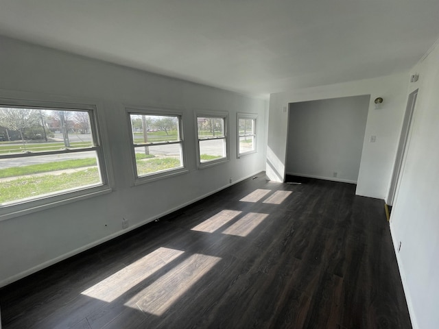 301 Michigan Ave, Bay City, MI 48708 - unfurnished room featuring dark wood-style flooring and baseboards