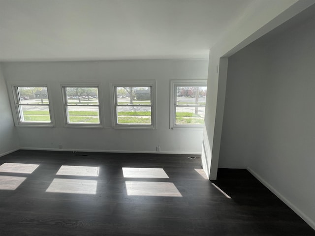 301 Michigan Ave, Bay City, MI 48708 - spare room with baseboards and dark wood-style floors