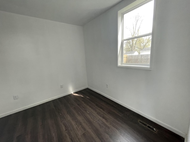 301 Michigan Ave, Bay City, MI 48708 - interior space with visible vents, baseboards, and dark wood-style floors