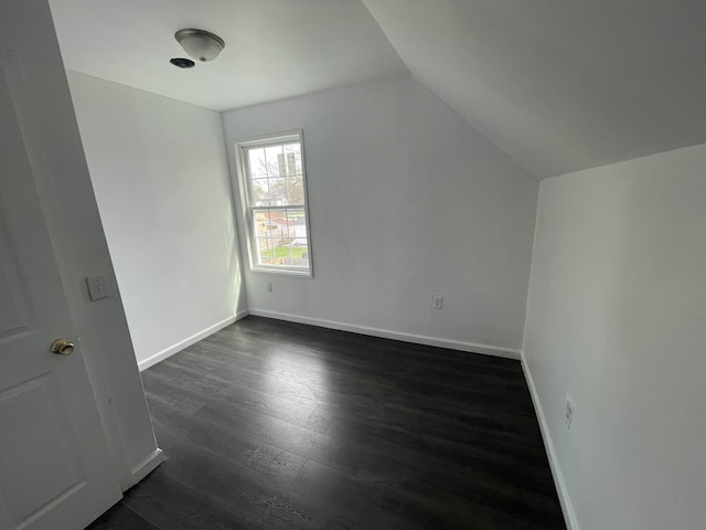 301 Michigan Ave, Bay City, MI 48708 - additional living space featuring vaulted ceiling, dark wood-style flooring, and baseboards