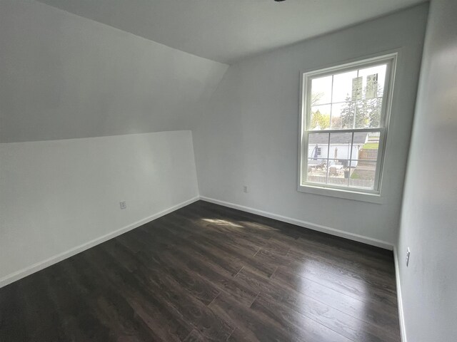 301 Michigan Ave, Bay City, MI 48708 - bonus room with dark wood finished floors, vaulted ceiling, and baseboards
