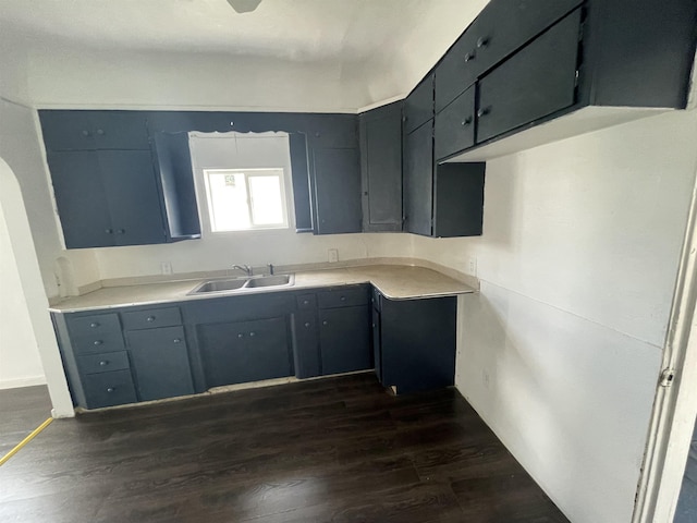 301 Michigan Ave, Bay City, MI 48708 - kitchen with a sink, light countertops, and dark wood-style floors