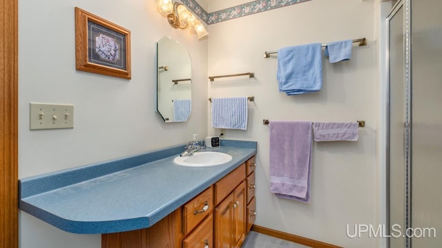 bathroom featuring a shower stall and vanity