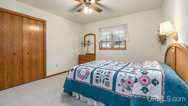 carpeted bedroom with baseboards, a ceiling fan, and a closet