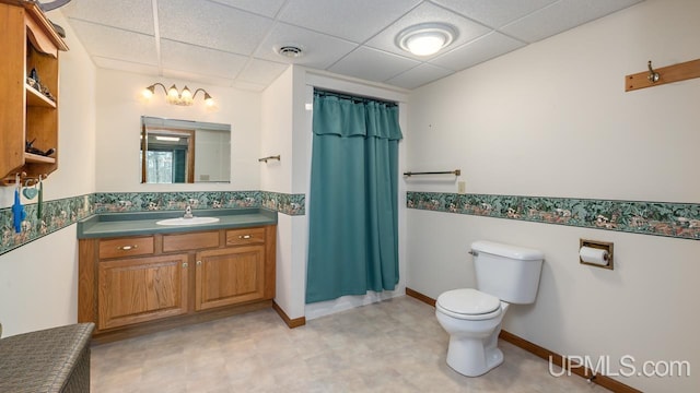 bathroom with toilet, a drop ceiling, tile patterned floors, visible vents, and vanity