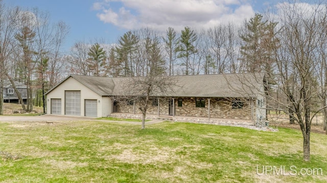 single story home with a porch, concrete driveway, a garage, and a front yard
