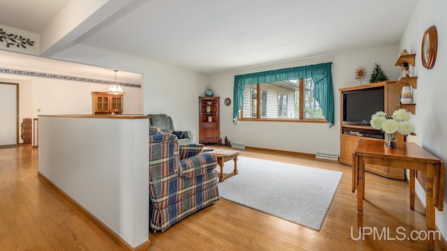 living room featuring light wood finished floors, baseboards, and visible vents