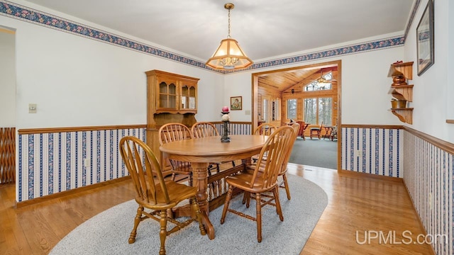 dining room with light wood-type flooring and wainscoting