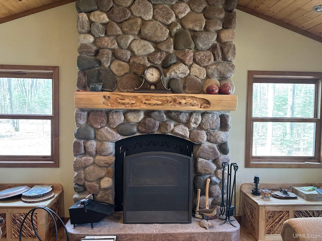 detailed view of wood ceiling, a stone fireplace, and wood finished floors