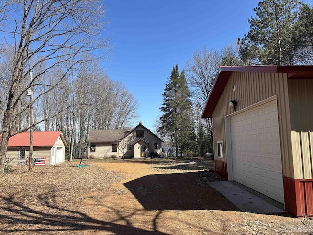 view of home's exterior featuring an outbuilding and a detached garage
