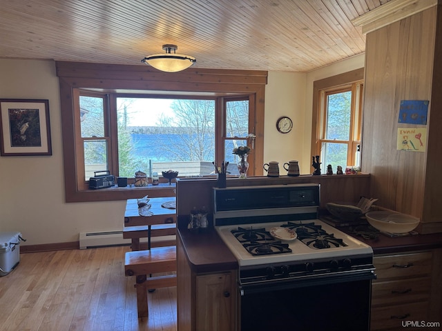 kitchen featuring range with gas stovetop, plenty of natural light, a baseboard radiator, light wood finished floors, and wood ceiling